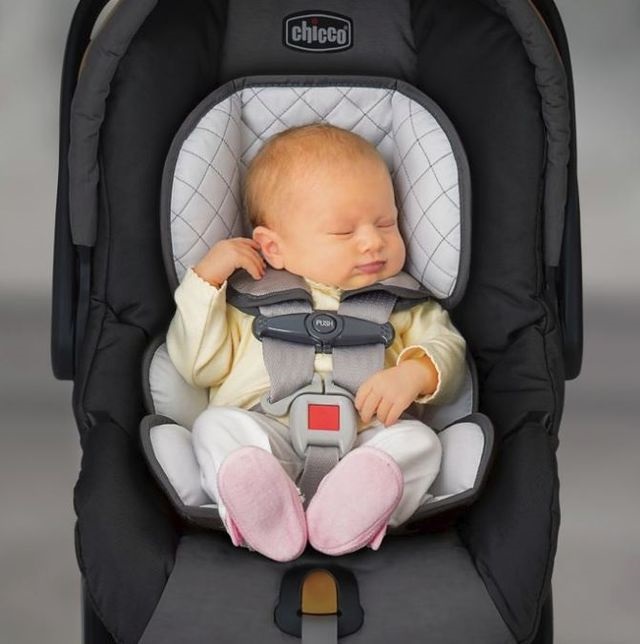 Best Car Seat 2019, cute baby in chicco car seat, wearing a yellow onesie.
